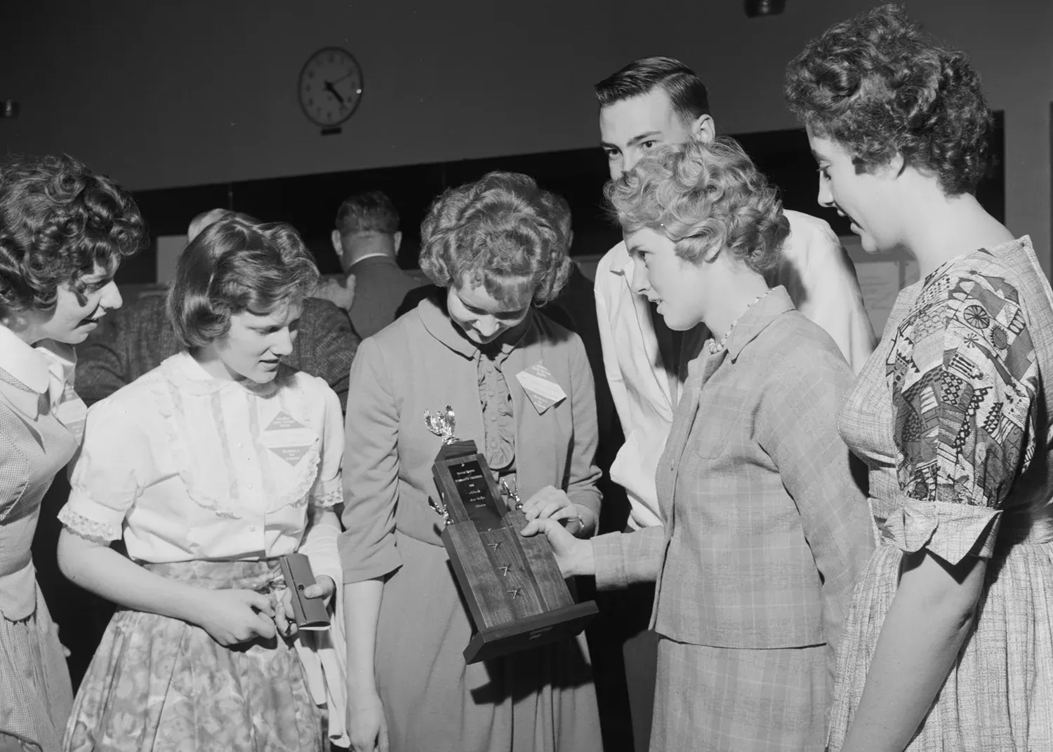 Students examining a trophy